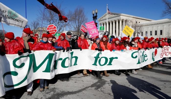 Pro-life activists parade in front of the U.S. Supreme Court during the annual March for Life in Washington, January 22, 2014. Pope Francis used Twitter to back the annual anti-abortion rally, which was expected to draw hundreds of thousands to Washington on Wednesday.