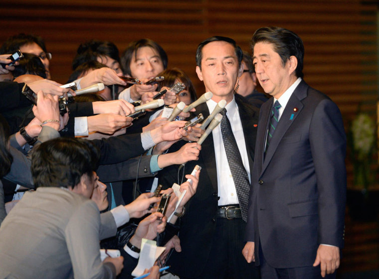 Japan's Prime Minister Shinzo Abe (R) speaks to the media at his official residence in Tokyo in this January 25, 2015 photo by Kyodo. Japan early on Sunday condemned a recording purporting to announce the execution of a Japanese citizen held by Islamic State militants and demanded the immediate release of another captive depicted as appearing on the image.