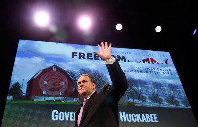 Former Governor of Arkansas Mike Huckabee waves after speaking at the Freedom Summit in Des Moines, Iowa, January 24, 2015.