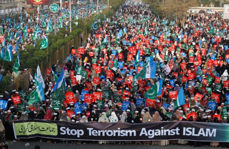 Supporters of Pakistan's political and religious party Jama'at e Islami hold signs during a protest against satirical French weekly newspaper Charlie Hebdo, which featured a cartoon of the Islamic prophet Muhammad as the cover of its first edition since an attack by Islamist gunmen, in Karachi, Pakistan, January 25, 2015.