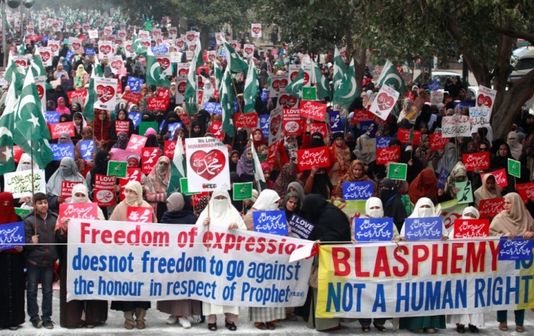 Supporters of Pakistan's political and religious party Jama'at e Islami hold signs in a protest against satirical French weekly newspaper Charlie Hebdo, which featured a cartoon of the Prophet Mohammad as the cover of its first edition since an attack by Islamist gunmen, in Lahore, Pakistan, January 25, 2015.