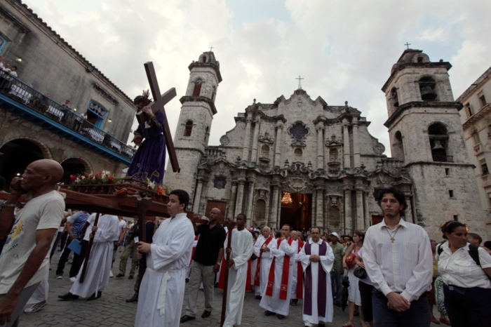Worshippers carry a statue of Jesus Christ during a Via Crucis (Way of the Cross) procession on Good Friday in Havana, April 6, 2012. Bells rang from Roman Catholic churches throughout Havana on Friday to remember the death of Jesus Christ as Cubans celebrated a holiday on Good Friday for the first time in more than half a century. The day off, granted at the request of Pope Benedict on his recent visit to the communist island, translated into quieter streets than usual, but only sparse attendance at a Mass in the city's main cathedral presided over by Cardinal Jaime Ortega.