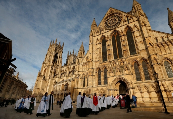 Members of the clergy enter York Minster in York, northern England, January 26, 2015.