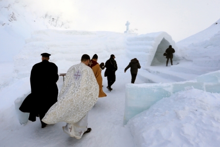 A group of priests of various congregations arrive for the inauguration of a church made entirely from ice at Balea Lac resort in the Fagaras mountains, Romania, January 29, 2015.