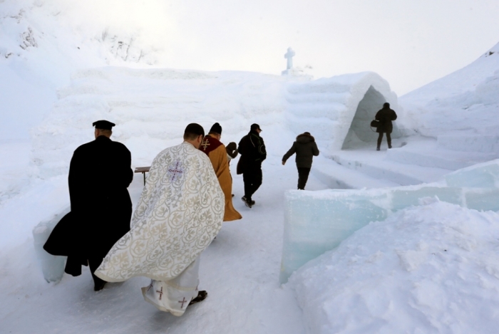 A group of priests of various congregations arrive for the inauguration of a church made entirely from ice at Balea Lac resort in the Fagaras mountains, Romania, January 29, 2015.