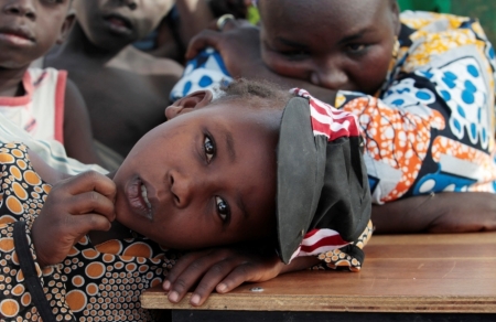 A girl displaced as a result of Boko Haram attack in the northeast region of Nigeria, rests her head on a desk at Maikohi secondary school camp for internally displaced persons in Yola, Adamawa state, Nigeria, January 13, 2015. Boko Haram says it is building an Islamic state that will revive the glory days of northern Nigeria's medieval Muslim empires, but for those in its territory life is a litany of killings, kidnappings, hunger and economic collapse.