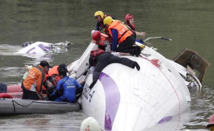 Rescuers pull a passenger out of the TransAsia Airways plane which crashed in Taiwan Wednesday.