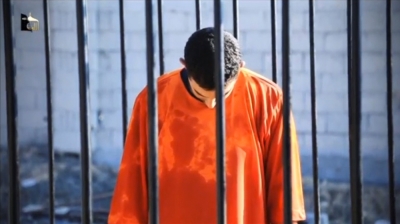 A man purported to be Islamic State captive Jordanian pilot Muath al-Kasaesbeh is seen standing in a cage in this still image from an undated video filmed from an undisclosed location made available on social media on February 3, 2015. Islamic State militants released the video on Tuesday purporting to show Kasaesbeh being burnt alive, and Jordanian state television said he was murdered a month ago. Reuters could not immediately confirm the video, which showed a man resembling the captive pilot standing in a black cage before being set ablaze.