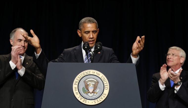 U.S. President Barack Obama takes the stage to speak at the National Prayer Breakfast in Washington, February 5, 2015. Flanking Obama are Pennsylvania Senator Robert Casey (L) and Mississippi Senator Roger Wicker.