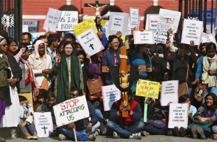 Demonstrators shout slogans as they hold placards during a protest outside a church in New Delhi, India, February 5, 2015.
