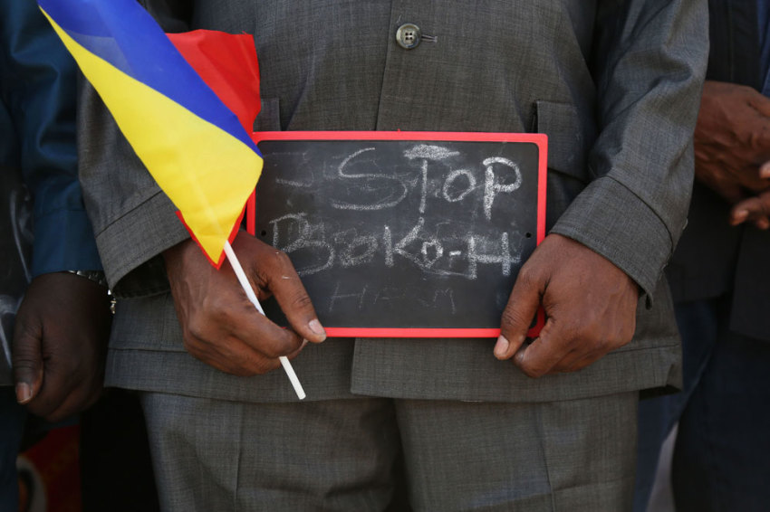 A man holds a sign that reads "Stop Boko Haram" at a rally to support Chadian troops heading to Cameroon to fight Boko Haram, in Ndjamena January 17, 2015.