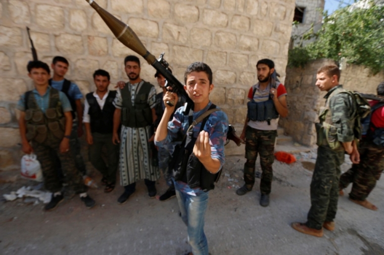 A Free Syrian Army fighter reacts to the camera at the Handarat camp frontline, an area located beside Aleppo Central prison, July 7, 2014.