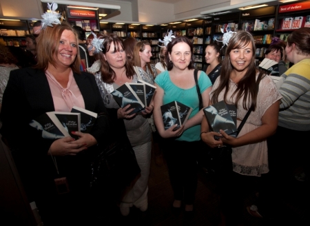 People wait for E L James, author of "Fifty Shades of Grey," during a book signing in London, England, September 6, 2012.