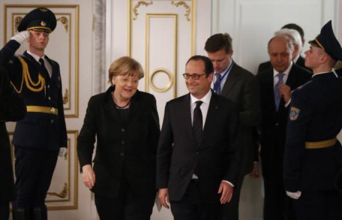 Germany's Chancellor Angela Merkel (L) and France's President Francois Hollande (R, front) walk after taking part in peace talks on resolving the Ukrainian crisis in Minsk, February 12, 2015.