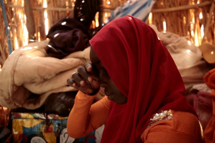 Displaced Sudanese girl Hawa Sliman Idriss, 13, who was raped last Friday by unidentified armed men, sits at her shelter at Otash Internally Displaced Persons Camp in Nyala, southern Darfur, March 18, 2009.