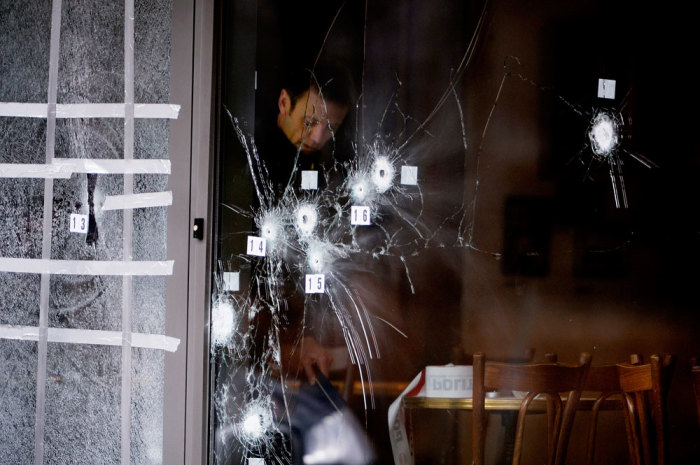 A police technician works next to the door to Krudttoenden in Oesterbro, Copenhagen, February 15, 2015. Danish police shot dead a gunman in Copenhagen on Sunday they believe was responsible for killing two civilians and wounding five police in separate attacks on a synagogue and an event promoting freedom of speech. Prime Minister Helle Thorning-Schmidt said the shootings, which bore similarities to an assault in Paris in January on the offices of weekly newspaper Charlie Hebdo, were terrorist attacks.
