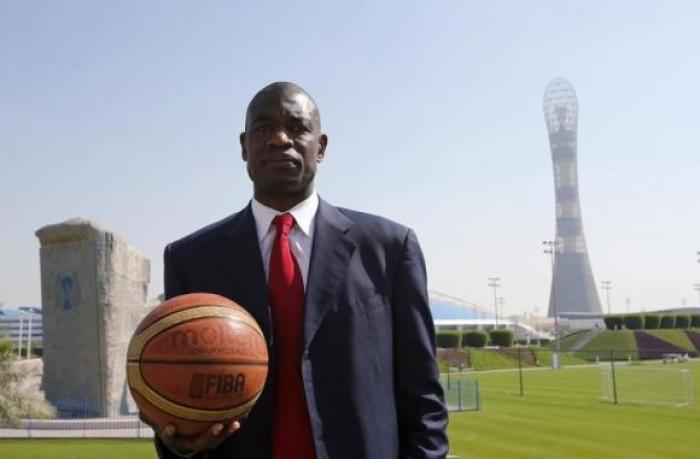 Former NBA star Dikembe Mutombo of U.S. poses before the start of a news conference at the Sports Congress and Exhibition at Aspire Dome in Doha November 12, 2012.