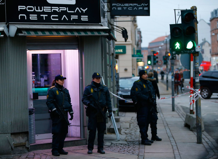Police officers control the street in front of an internet cafe in Norrebro district in Copenhagen, February 15, 2015. Police shot dead a gunman on Sunday whose attacks on a Copenhagen synagogue and an event promoting free speech may have been inspired by an attack on French satirical weekly Charlie Hebdo last month, authorities said.