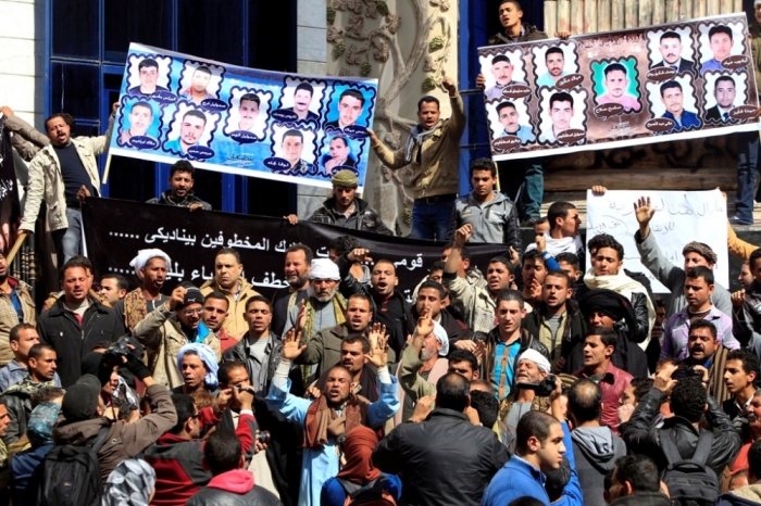 Relatives of 27 Egyptian Coptic Christian workers who were kidnapped in the Libyan city of Sirte, take part in a protest to call for their release, in Cairo, February 13, 2015. Egyptian Copts have been targeted in Libya before during the chaos that broke out when militias that fought together to oust dictator Muammar Gaddafi then trained their arms on one another.
