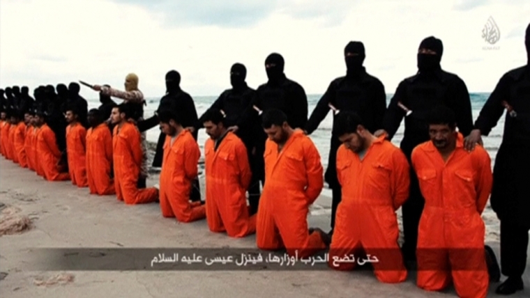 Men in orange jumpsuits purported to be Egyptian Christians held captive by the Islamic State kneel in front of armed men along a beach said to be near Tripoli, in this still image from an undated video made available on social media on February 15, 2015. Islamic State released the video on Sunday purporting to show the beheading of 21 Egyptian Christians kidnapped in Libya. In the video, militants in black marched the captives to a beach that the group said was near Tripoli. They were forced down onto their knees, then beheaded. Egypt's state news agency MENA quoted the spokesman for the Coptic Church as confirming that 21 Egyptian Christians believed to be held by Islamic State were dead.