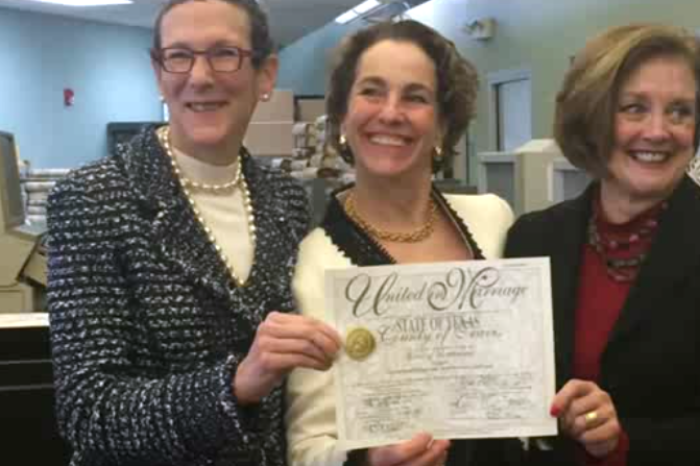 Sarah Goodfriend and Suzanne Bryant hold up their newly-issued Texas marriage license after a court order forced the Travis County Clerk to issue a marriage license to the couple on Thursday, Feb. 19, 2015.