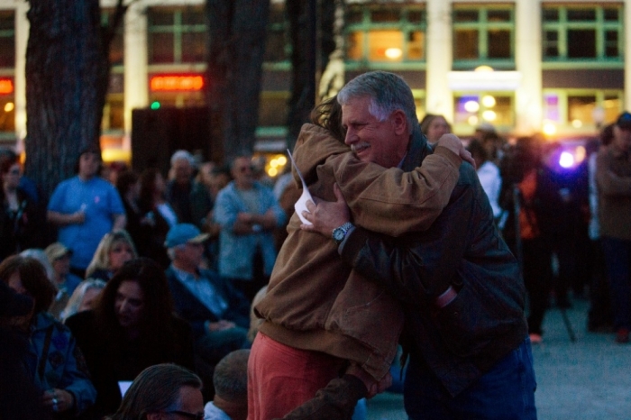 Carl Mueller is greeted by friends at a candlelight memorial honoring his daughter aid worker Kayla Mueller at the Prescott's Courthouse Square in Prescott, Arizona, February 18, 2015. Friends and colleagues of Mueller, the aid worker who died while a captive of militants of the Islamic State group in Syria, remembered her on Saturday in a candlelight vigil as someone who was trying to give back in gratitude for a life of freedom. Mueller, 26, was confirmed to have died under circumstances that remain unclear about 18 months after she was abducted while leaving a hospital in northern Syria.