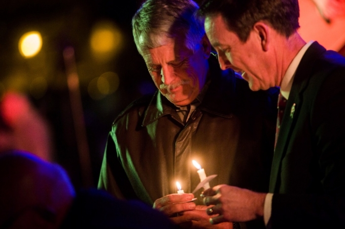 Carl Mueller holds his candle during a candlelight memorial honoring his daughter aid worker Kayla Mueller at the Prescott's Courthouse Square in Prescott, Arizona, February 18, 2015. Friends and colleagues of Mueller, the aid worker who died while a captive of militants of the Islamic State group in Syria, remembered her on Saturday in a candlelight vigil as someone who was trying to give back in gratitude for a life of freedom. Mueller, 26, was confirmed to have died under circumstances that remain unclear about 18 months after she was abducted while leaving a hospital in northern Syria.