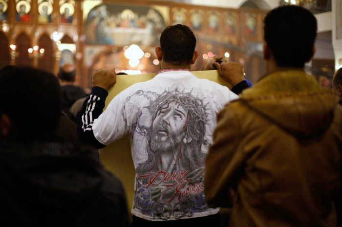 Jordanian Christians attend mass at the Coptic Orthodox Patriarchate in Amman, in memory of the Egyptians beheaded in Libya, February 18, 2015. Christians in Amman held the prayer service, which was attended by representatives of the churches in Jordan, for the Egyptian Christians beheaded by Islamic State in Libya last week.