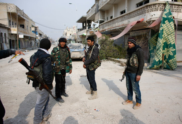 Fighters of the Kurdish People's Protection Units (YPG) patrol in the streets of the northern Syrian town of Kobani January 28, 2015. Kurdish forces battled Islamic State fighters outside Kobani on Tuesday, a monitoring group said, a day after Kurds said they had taken full control of the northern Syrian town following a four-month battle. Known as Ayn al-Arab in Arabic, the mainly Kurdish town close to the Turkish border has become a focal point in the international fight against Islamic State, an al Qaeda offshoot that has spread across Syria and Iraq.