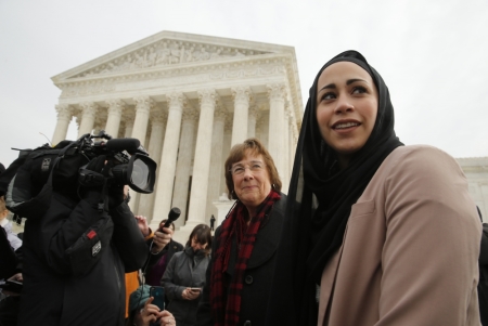 Muslim woman Samantha Elauf (R), who was denied a sales job at an Abercrombie Kids store in Tulsa in 2008, stands with U.S. Equal Employment Opportunity Commission (EEOC) lead attorney Barbara Seely (C) at the U.S. Supreme Court in Washington, February 25, 2015. The Court on Wednesday considered whether Elauf, who wears a head scarf, or hijab, was required to specifically request a religious accommodation at her job interview at the store in Tulsa in 2008 when she was 17. The company denied Elauf the job on the grounds that wearing the scarf violated its "look policy" for members of the sales staff.