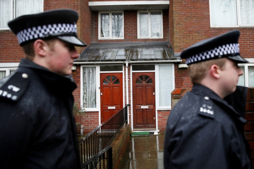 Two police officers walk outside a flat in London, February 26, 2015. Local media reported that the flat is the former home of Mohammed Emwazi. Investigators believe that the "Jihadi John" masked fighter who fronted Islamic State beheading videos is a British man named Mohammed Emwazi, two U.S. government sources said on Thursday. He was born in Kuwait and comes from a prosperous family in London, where he grew up and graduated with a computer programming degree, according to The Washington Post.