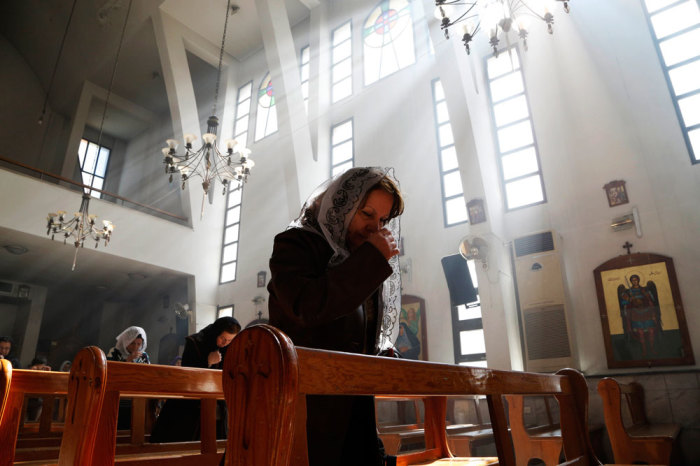 An Assyrian woman attends a mass in solidarity with the Assyrians abducted by Islamic State fighters in Syria earlier this week, inside Ibrahim al-Khalil church in Jaramana, eastern damascus March 1, 2015. Militants in northeast Syria are now estimated to have abducted at least 220 Assyrian Christians this week, a group monitoring the war reported.