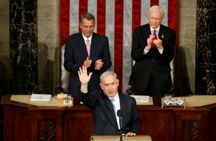 Israeli Prime Minister Benjamin Netanyahu (L) acknowledges applause at the end of his speech to a joint meeting of Congress in the House Chamber on Capitol Hill in Washington, March 3, 2015.