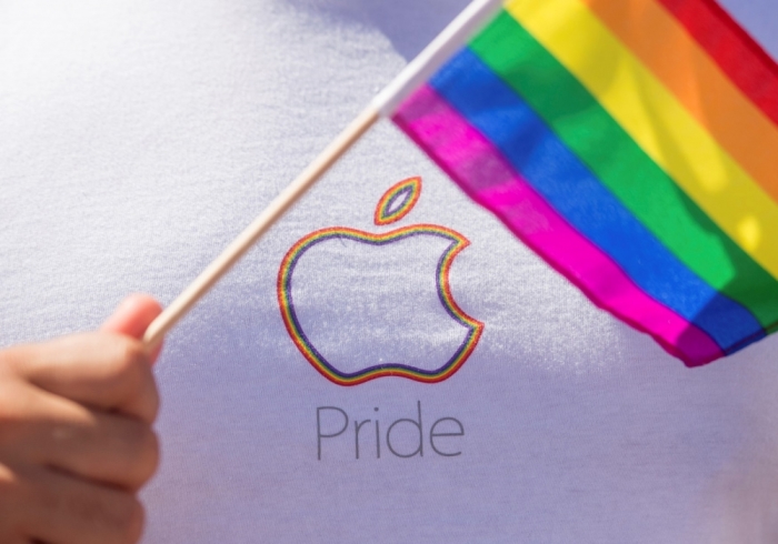 An Apple employee waves a rainbow flag before marching in the San Francisco Gay Pride Festival in California, June 29, 2014. Thousands of Apple employees donned specially designed T shirts at the festival and marched in unison. This year's turnout was largest in the company's history, several Apple employees told Reuters.