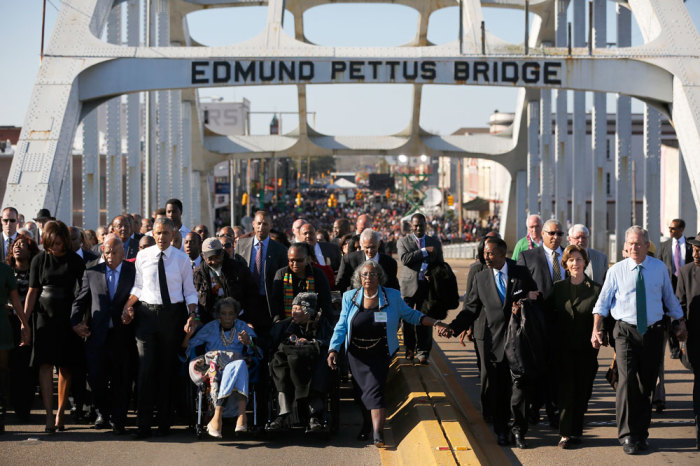 U.S. President Barack Obama (3rd L) participates in a march across the Edmund Pettus Bridge in Selma, Alabama, March 7, 2015. Also pictured are first lady Michelle Obama (L), U.S. Representative John Lewis (D-GA) (2nd L), former first lady Laura Bush (2nd R) and former president George W. Bush (R). The event comes on the 50th anniversary of the 'Bloody Sunday' march at the bridge, where police and state troopers beat and used tear gas against peaceful marchers who were advocating against racial discrimination at the voting booth.