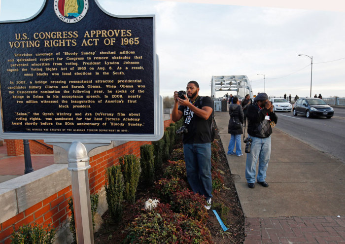 People take pictures along the Edmund Pettus Bridge commemorating the 50th anniversary march in Selma, Alabama March 6, 2015. U.S. President Barack Obama will deliver remarks at the bridge on Saturday to commemorate the 50th anniversary of the Selma to Montgomery civil rights marches. On March 7, 1965, roughly 600 civil rights activists began a 50 mile (80km) march from Selma to Montgomery, Alabama, in an effort to end racial discrimination in voter registration.