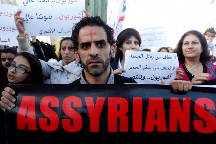 Assyrians hold banners as they march in solidarity with the Assyrians abducted by Islamic State fighters in Syria earlier this week, in Beirut, Lebanon, February 28, 2015. Militants in northeast Syria are now estimated to have abducted at least 220 Assyrian Christians this week, a group monitoring the war reported. The banner (R) reads, 'We are not afraid of whom kills the flesh, we are not afraid of who destroys the stone. Assyrians and victorious.'