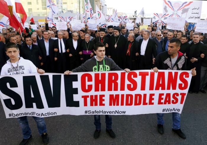 Assyrians hold banners as they march in solidarity with the Assyrians abducted by Islamic State fighters in Syria earlier this week, in Beirut, Labanon, February 28, 2015. Militants in northeast Syria are now estimated to have abducted at least 220 Assyrian Christians this week, a group monitoring the war reported.