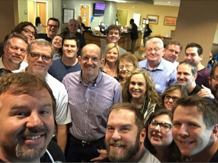 Casting Crowns' lead singer Mark Hall (left foreground) is surrounded by friends, family and band mates who prayed for him just before he had surgery to remove a cancerous kidney on Wednesday March 11, 2015.