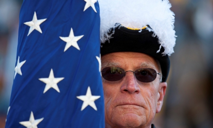 A member of the Knights of Columbus holds the U.S. flag outside the State House during a Pro-Life rally in Columbia, South Carolina, January 14, 2012.