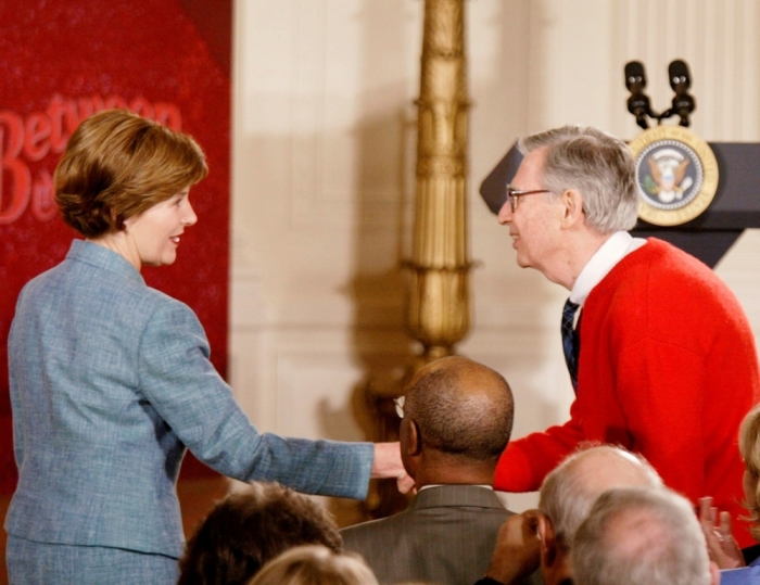 First lady Laura Bush greets children television personality 'Mister Rogers' in the East Room of the White House, April 3, 2002. The first lady will be the honorary chairperson of PBS's designated reader campaign promoting children's literacy.