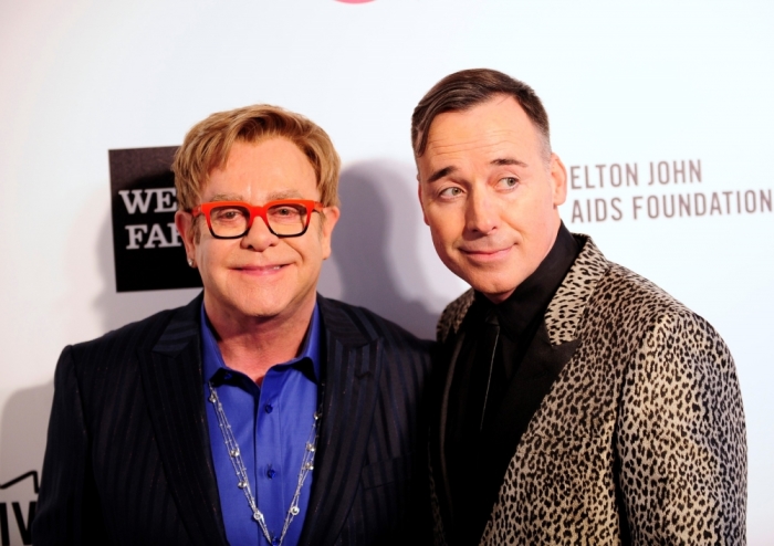 Musician Elton John (L) and his husband David Furnish arrive at the 2014 Elton John AIDS Foundation Oscar Party in West Hollywood, California, March 2, 2014.