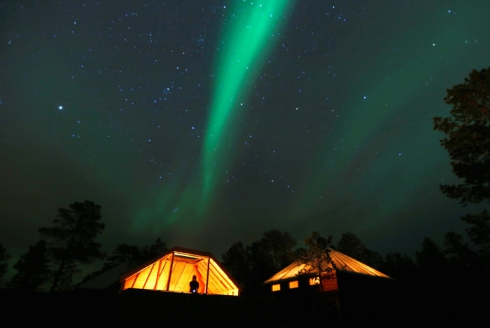 The Aurora Borealis (Northern Lights) is seen over a mountain camp north of the Arctic Circle, near the village of Mestervik, Norway, late October 1, 2014.
