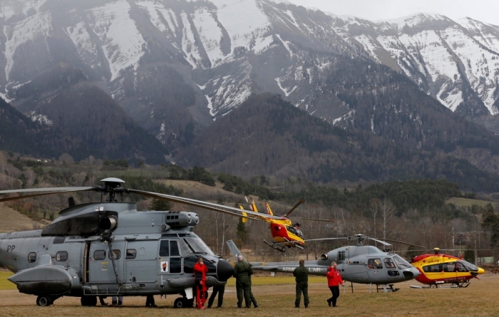 Rescue helicopters from the French Securite Civile and the Air Force are seen in front of the French Alps during a rescue operation near to the crash site of an Airbus A320, near Seyne-les-Alpes, March 24, 2015. An Airbus plane operated by Lufthansa's Germanwings budget airline, en route from Barcelona to Duesseldorf, crashed in a remote snowy area of the French Alps on Tuesday and all 150 on board were feared dead.