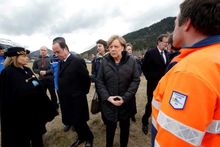 French President Francois Hollande (L), Spain's Prime Minister Mariano Rajoy (R) and German Chancellor Angela Merkel (C) speaks with rescue workers as they arrive in Seyne-les-Alpes March 25, 2015, the day after the air crash of a Germanwings Airbus A320. Hollande, Merkel and Rajoy arrived in the village of Seyne-les-Alpes, where French investigators have set up headquarters for search operations in the nearby ravine where an Airbus plane smashed into a mountain, ahead of an international homage to the 150 victims.