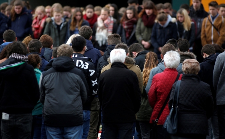 Students of Joseph-Koenig-Gymnasium high school hold a minute of silence outside their school in Haltern am See, March, 26, 2015. The deaths of 16 teenage students and two young teachers in the Germanwings plane crash in the French Alps left the lakeside town of Haltern am See in a state of shock on Wednesday, with the German nation sharing in their mourning and grief.