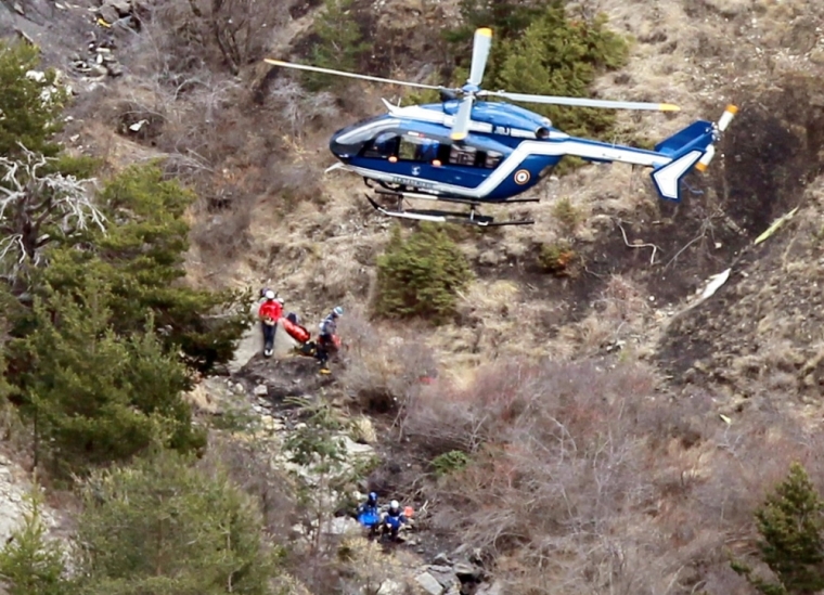 A French gendarme helicopter flies over the crash site of an Airbus A320, near Seyne-les-Alpes, March 25, 2015. French investigators will sift through wreckage on Wednesday for clues into why a German Airbus operated by Lufthansa's Germanwings budget airline plowed into an Alpine mountainside, killing all 150 people on board including 16 schoolchildren returning from an exchange trip to Spain.