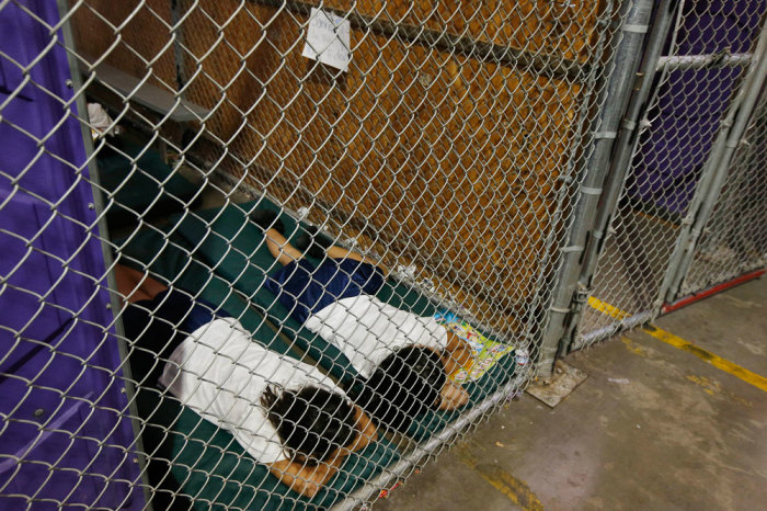 Two female detainees sleep in a holding cell at the U.S. Customs and Border Protection (CBP) Nogales Placement Center in Nogales, Arizona, in this June 18, 2014 file photo. Hundreds of mostly Central American immigrant children being processed and held at the center are separated by age and gender.