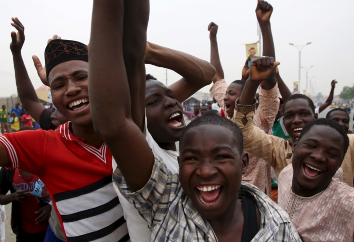 Supporters of the presidential candidate Muhammadu Buhari and his All Progressive Congress (APC) party celebrate in Kano March 31, 2015. Nigeria's opposition APC declared an election victory on Tuesday for former military ruler Buhari and said Africa's most populous nation was witnessing history with its first democratic transfer of power.