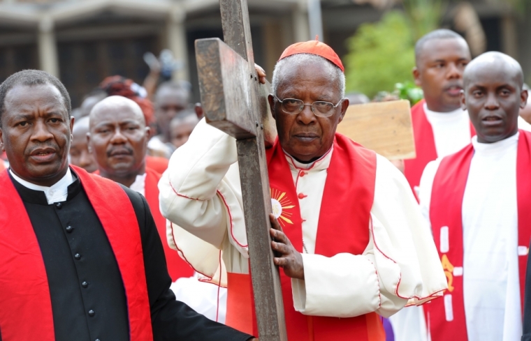 Cardinal John Njue carries a cross during a Good Friday procession outside the Holy Family Basilica Catholic Church in Kenya's capital Nairobi, April 3, 2015. The re-enactment is one of many such processions that are performed around the world during Easter celebrations.